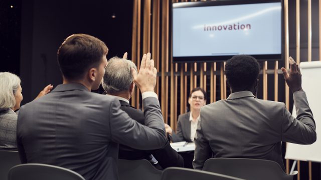 Asking question on innovation to conference speaker