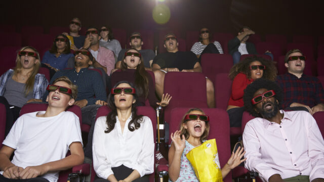 Audience In Cinema Wearing 3D Glasses Watching Horror Film