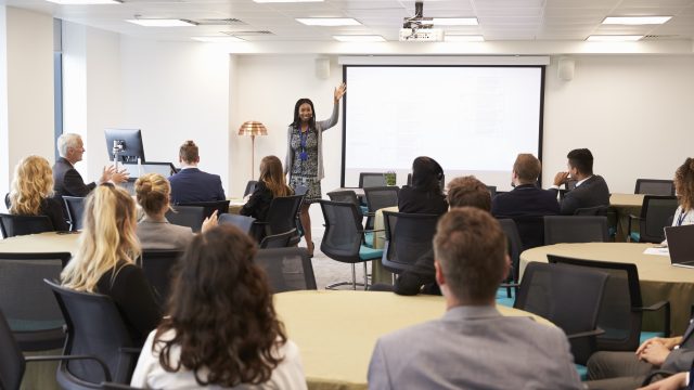 Businesswoman Making Presentation At Conference
