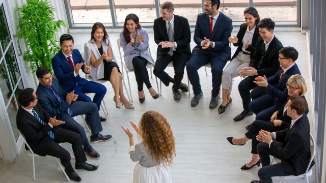 Business people talking at group meeting.