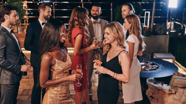 Group of beautiful young people in formalwear communicating and