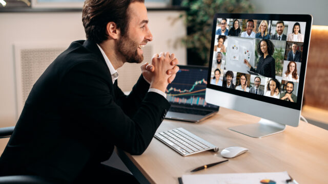 Online video communication. Smart caucasian male stock agent, conducts online trading lesson, talking by a video conference with multiracial team, working out a crypto strategy, discussing risks
