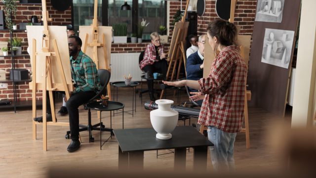 Painter teacher showing model for drawing course explaining illustration technique
