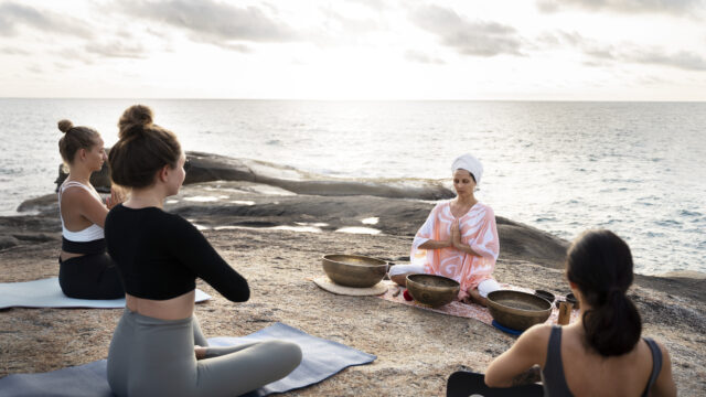 senior-meditation-guide-with-singing-bowls-sea