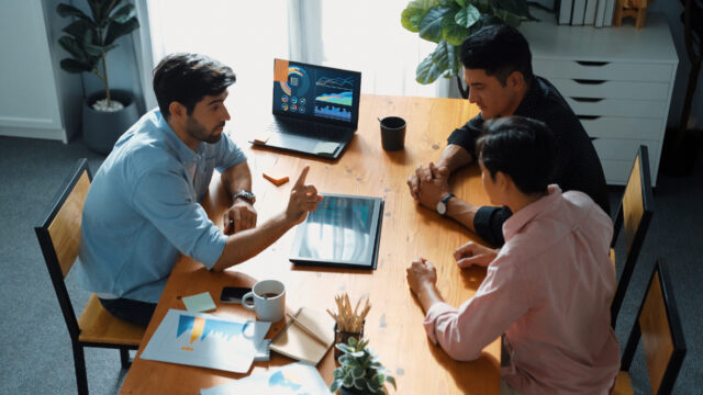Smart manager explain financial graph to colleague at meeting room. Convocation.