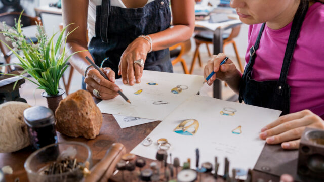Teacher jeweler and student make jewelry in workshop