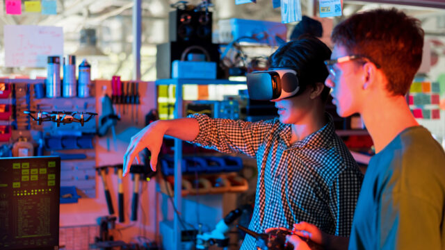 Teens remotely controlling robots in a laboratory