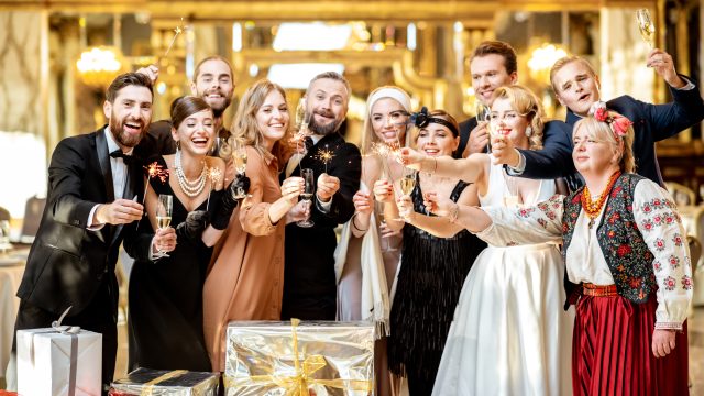 Well-dressed people celebrating New Year indoors
